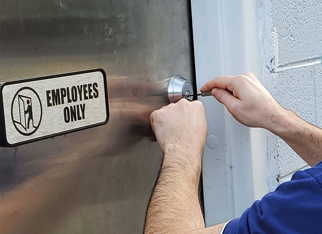 locksmith unlocking a commercial deadbolt