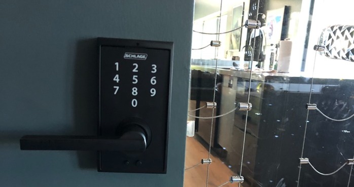 A newly installed keypad lock in an indoors business setting.