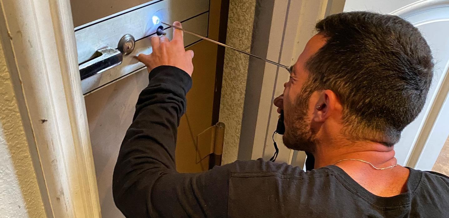 A West Coast Locksmith tech works on opening a safe.