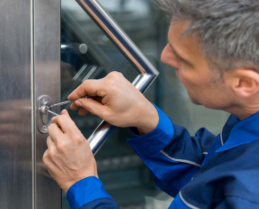 Locksmith picking a door lock during an emergency lockout.